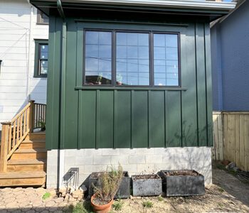8 Earthy Green Board And Batten Siding On Addition